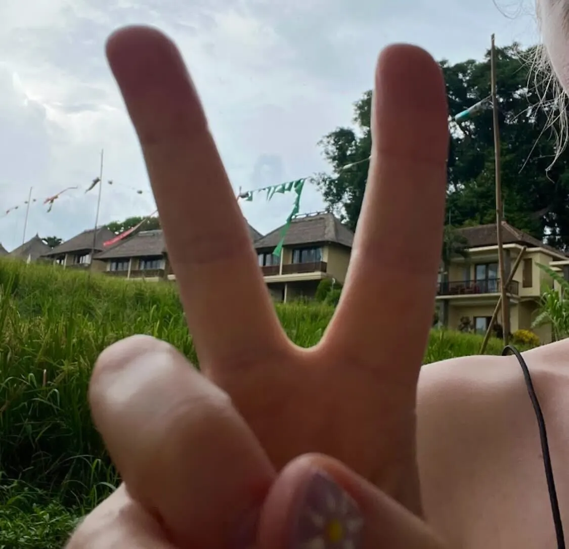 Girl doing the peace sign in Bali.